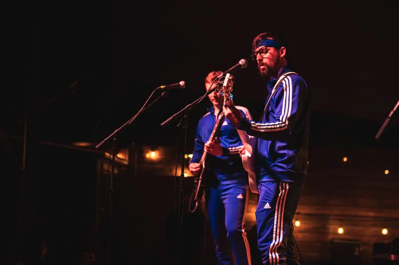 Wrestle With Jimmy on stage in matching blue tracksuits