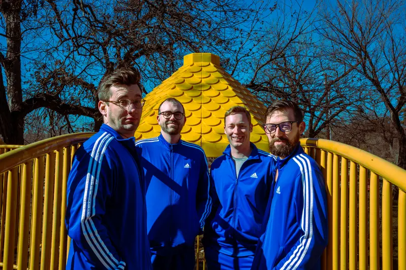 Band portrait on a yellow playground bridge